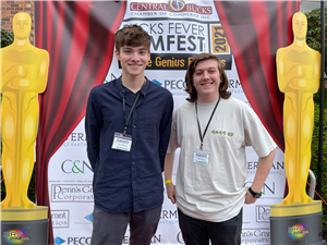 Luke and Billy stand in front of the Bucks Film Festival backdrop